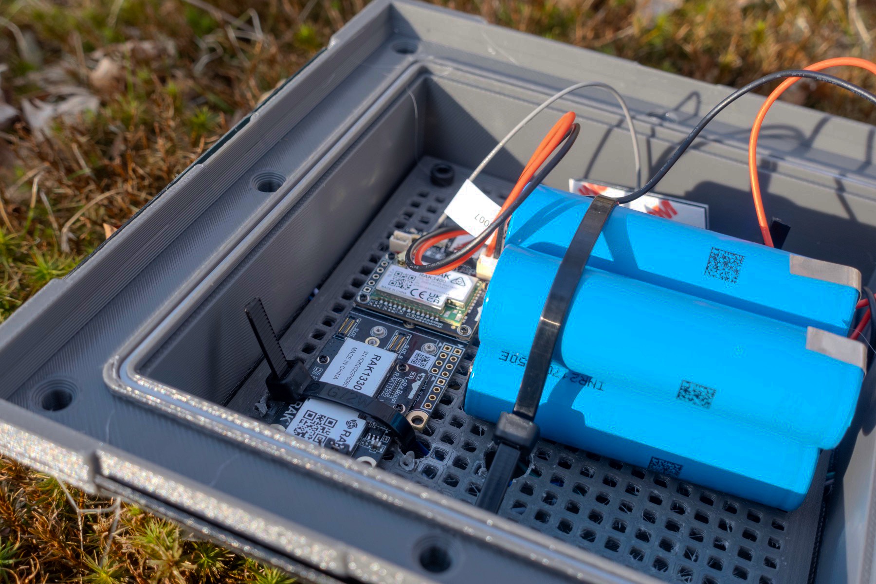 Open 1W lantern showing the RAK radio stack beside the larger battery reserve.
